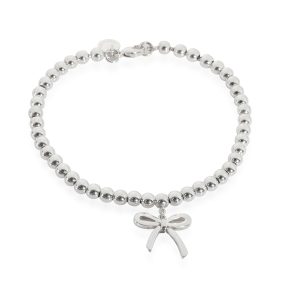 Tiffany Co Bow charm Bead Bracelet in Sterling Silver Louis Vuitton Montaigne BB Emplant Tourtrell Creme Hand Bag