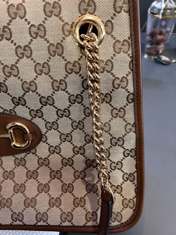 image 486a7619 e404 4811 a063 d5c7ddc66095 Gucci 1956 horsebit chain tote in monogram canvas and brown leather