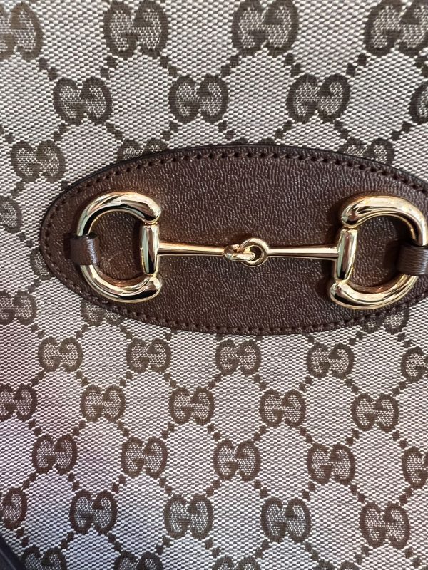 image bcd8e6be bf9c 4c51 a441 fd7173cd2698 Gucci 1956 horsebit chain tote in monogram canvas and brown leather