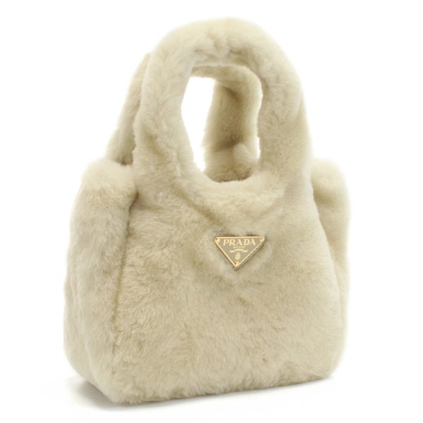 pra1ba349011 1 Prada Shearling Mini Handbag Logo Plate Beige