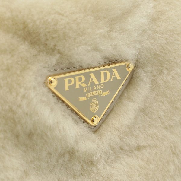 pra1ba349011 2 Prada Shearling Mini Handbag Logo Plate Beige