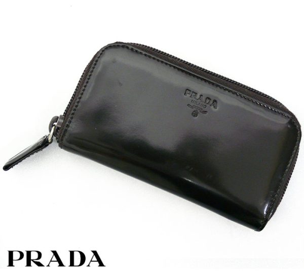 imgrc0064197804 Prada Logo Engraved Patent Round Zip Key Case Black