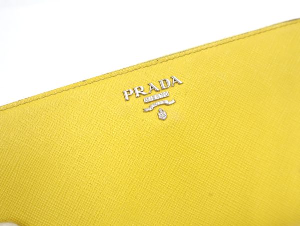 2000234256300009 3 Prada Saffiano long wallet yellow